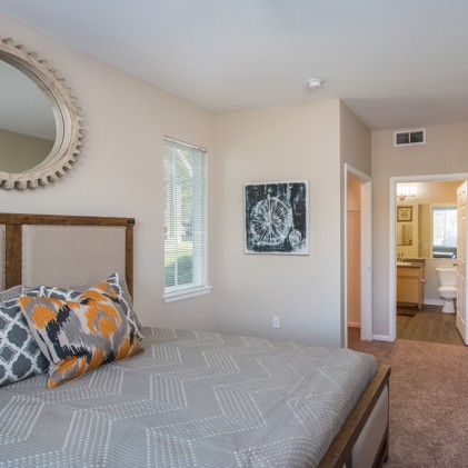 Bedroom setup includes a bed, dresser, and mirror.
